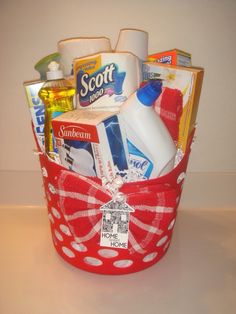 a red basket filled with lots of toiletries on top of a white countertop