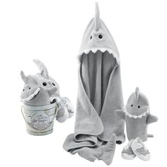 a stuffed shark and its baby in a bathrobe with a cup of ice cream