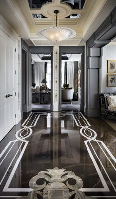 an elegant hallway with black and white marble flooring