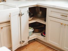 an open cabinet in the corner of a kitchen