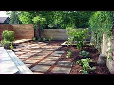 a backyard garden with brick walkways and trees