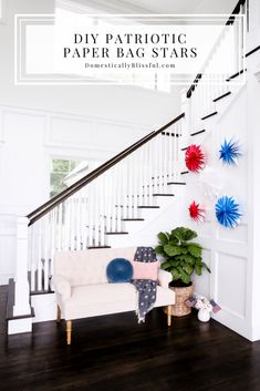 a white couch sitting under a stair case