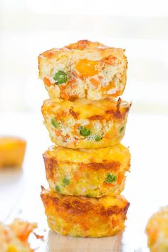 three mini quiche cups stacked on top of each other with cheese and vegetables in them