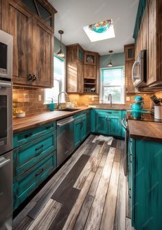 a kitchen with teal cabinets and wood floors