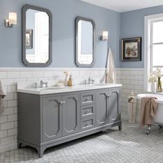 a bathroom with blue walls and two mirrors on the wall next to a bathtub