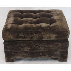 a brown velvet footstool sitting on top of a white floor