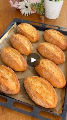 a pan filled with bread sitting on top of a wooden table