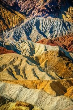 an aerial view of mountains and valleys in the desert