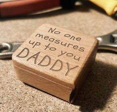 a small wooden box that says no one measures up to you daddy