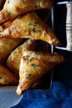 baked pastries in a metal pan on a blue cloth