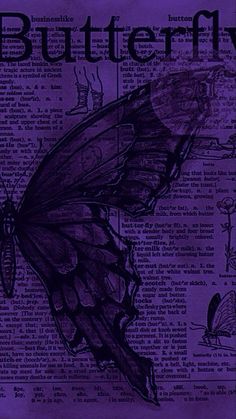 a purple butterfly sitting on top of an old book