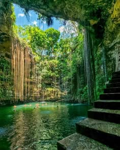 some people are swimming in the water near stairs