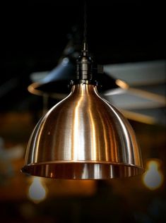 a shiny metal light hanging from a ceiling