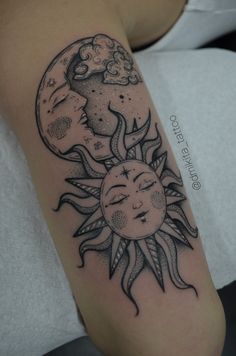 a woman with a sun and moon tattoo on her arm