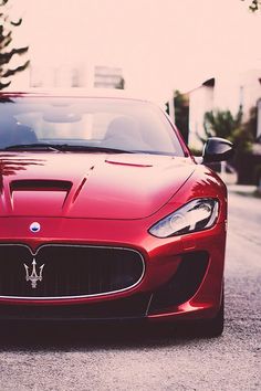 a red sports car is parked on the street