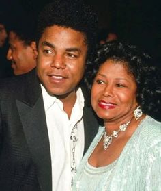 a man standing next to a woman at a formal event