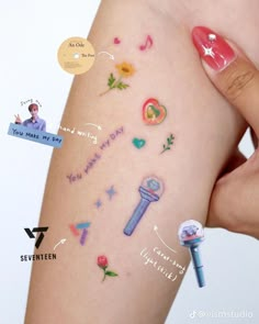 a woman's arm with various stickers on it