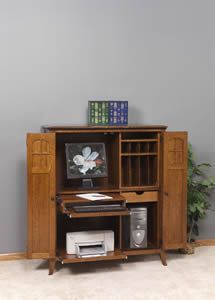 a computer desk with a monitor and printer on it