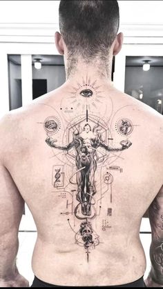 the back of a man's body with tattoos on it