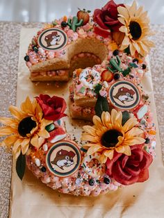 a decorated cake with sunflowers and flowers on it