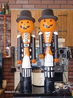 two wooden nutcrackers dressed in black and orange