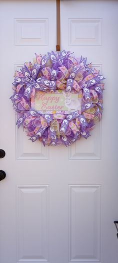 a purple wreath hanging on the front door