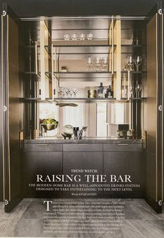 an advertisement for a kitchen with stainless steel cabinets and glass shelves in the center, along with wine glasses on top