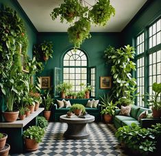 a living room filled with lots of green furniture and potted plants on the walls