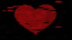 a red heart shaped object in the dark