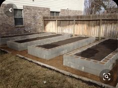 an outdoor garden with raised beds in the ground