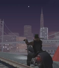 a man riding on the back of a motorcycle next to a tall building at night