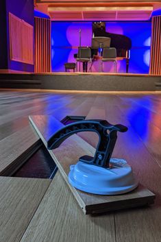 a blue and black object on the floor in front of a piano