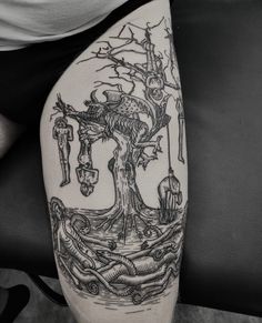 a black and white tattoo with an image of a tree