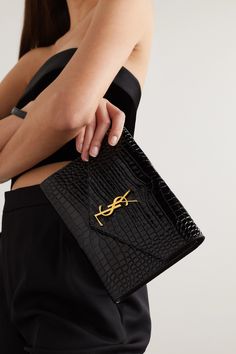 SAINT LAURENT's clutch has been made in Italy from glossy croc-effect leather in a slim, envelope shape and has enough space for your phone, cards and keys. Topped with the brand's iconic 'YSL' plaque, it comes with a detachable wristlet strap to free up your hands. Clutch Designer Luxury, Ysl Croc Bag, Ysl Uptown Pouch Outfit, Ysl Clutch Bag, Clutch Purse Outfit, Ysl Clutch Outfit, Ysl Envelope Clutch, Purse List, Clutch Outfit