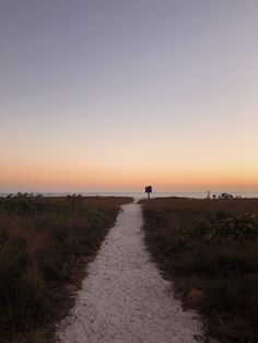 a path leading to the beach at sunset