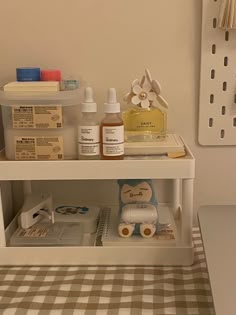 the shelf in the bathroom is filled with personal care items