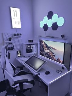 a computer desk with two monitors and a laptop