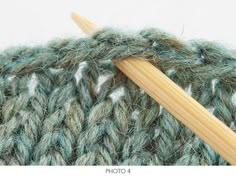 a close up view of a knitting needle and yarn