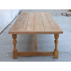 a wooden table sitting on top of a sidewalk