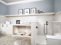 a bathroom with tile flooring and white walls