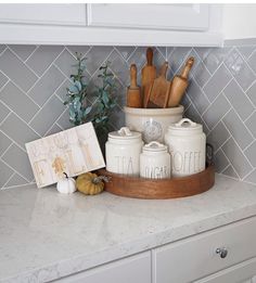 kitchen utensils and wooden spoons are sitting on the counter