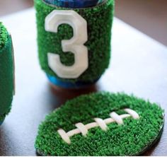 some cupcakes are decorated to look like grass with a football on it and the number three