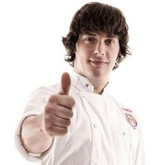 a man in a chef's uniform giving the thumbs up sign with his right hand