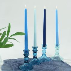 three blue candles sitting next to each other