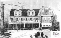 an old black and white photo of a large house with two storyed houses in the snow