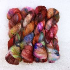 several skeins of multicolored yarn sitting on top of each other