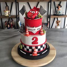 a birthday cake decorated with cars and race flags