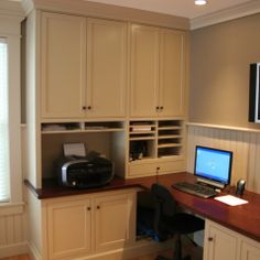 a computer desk with a laptop on top of it