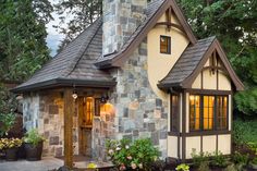 a small house with a stone chimney and windows