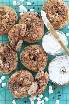 chocolate chip donuts with marshmallows and icing on a cooling rack